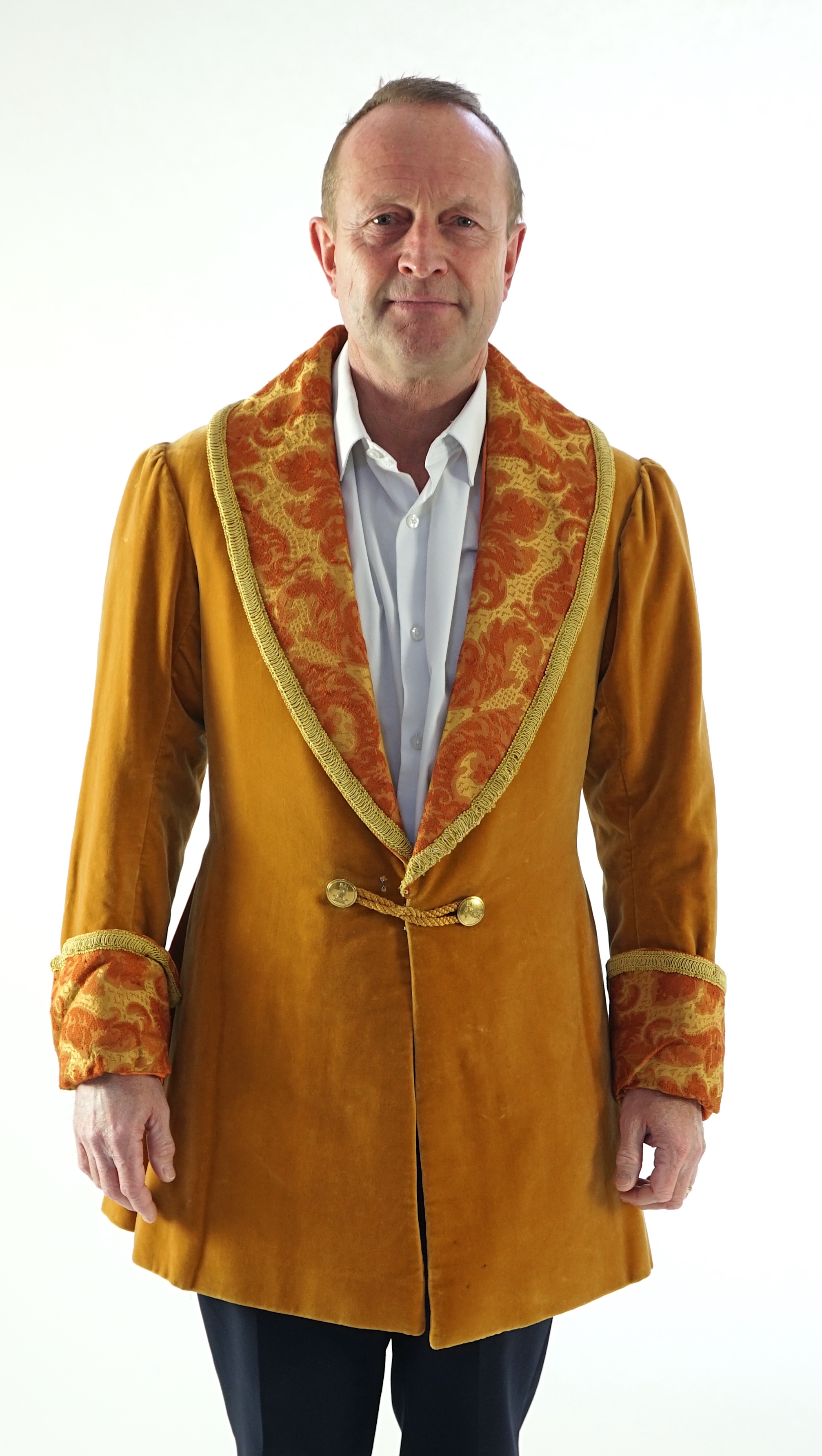 A man's 19th century smoking jacket, mustard velvet, with brocade lapels and cuffs. Ex Royal Opera House 'Arabella'